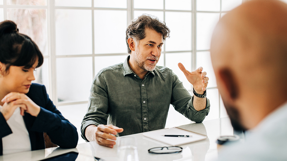 Man having a discussion with his team in an office